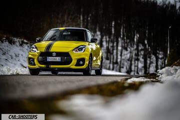 Suzuki Swift Sport – front three-quarter, yellow on a snowy mountain road