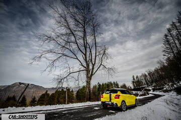 Suzuki Swift Sport – rear three-quarter, yellow on a snowy winding road