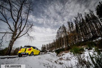 Suzuki Swift Sport – rear three-quarter, yellow on a snowy mountain road
