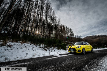 Suzuki Swift Sport – front three-quarter, yellow on a snowy country road