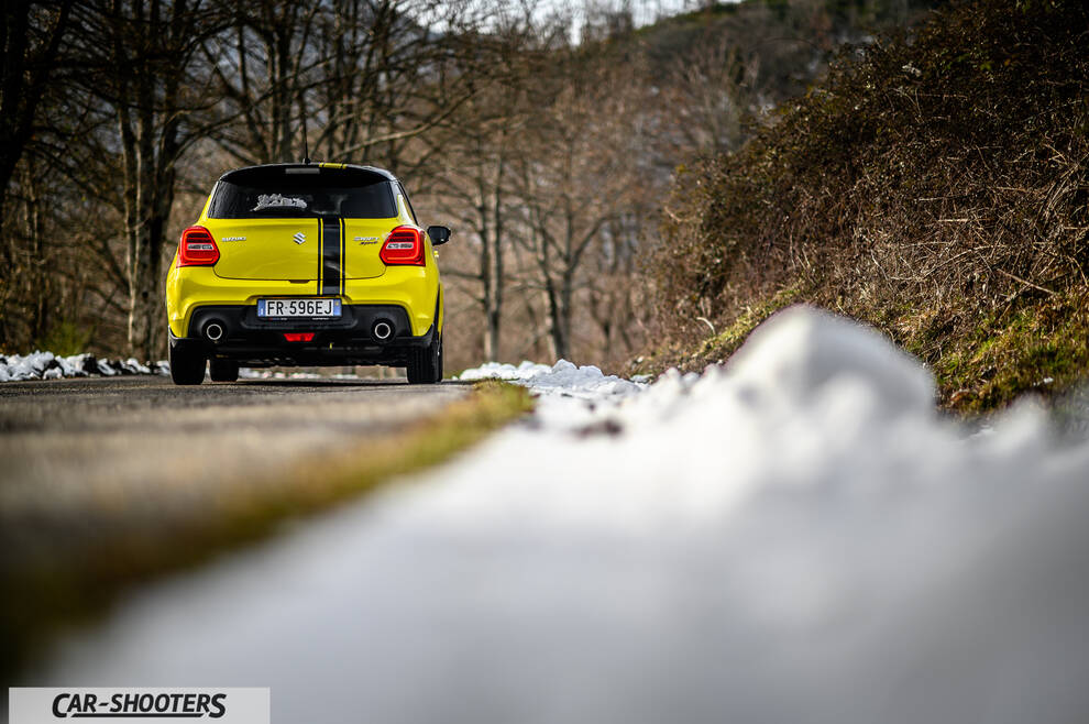 Suzuki Swift Sport – rear view, yellow on a snowy road