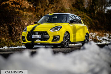 Suzuki Swift Sport – front three-quarter, yellow on a snowy road