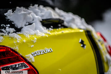 Suzuki Swift Sport – rear view, yellow covered in snow
