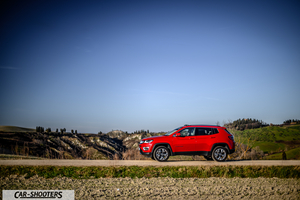 Jeep Compass – side profile, red on a country road