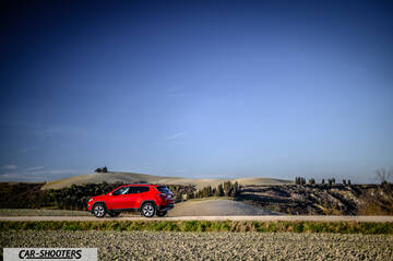 Jeep Compass – rear three-quarter, red on a country road