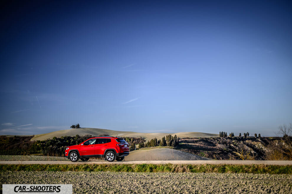 Jeep Compass – rear three-quarter, red on a country road