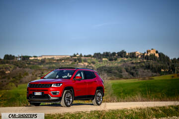 Jeep Compass – front three-quarter, red on a country road