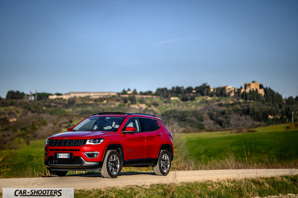 Jeep Compass – front three-quarter, red on a country road
