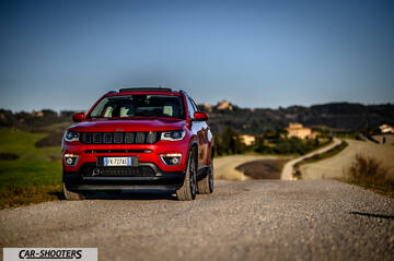Jeep Compass – front three-quarter, red on a country road