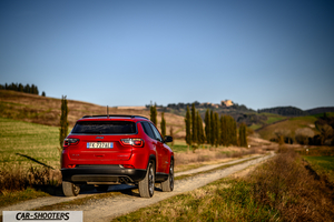 Jeep Compass – rear view, red on a country road