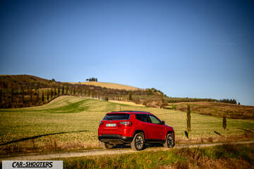 Jeep Compass – rear three-quarter, red on a country road