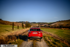 Jeep Compass – rear view, red on a country road