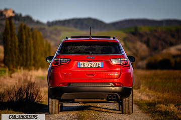 Jeep Compass – rear view, red on a country road