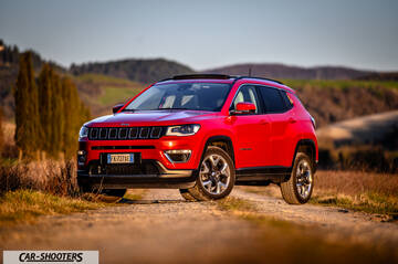 Jeep Compass – front three-quarter, red on a country road