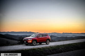 Jeep Compass – front three-quarter, red on a country road