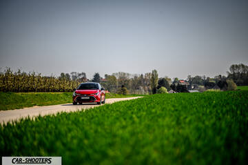 Toyota Corolla Hybrid – front three-quarter, red on a country road