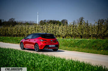 Toyota Corolla Hybrid – rear three-quarter, red on a country road