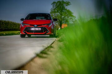 Toyota Corolla Hybrid – front three-quarter, red on a country road