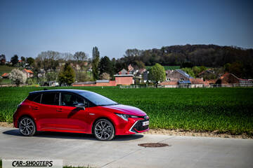 Toyota Corolla Hybrid – front three-quarter, red on a country road