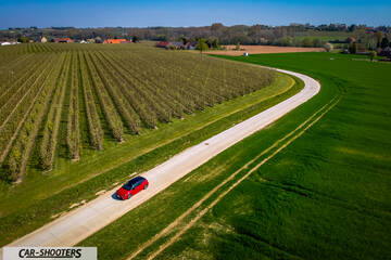 Toyota Corolla Hybrid – side profile, red on a country road