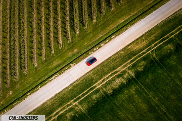 Toyota Corolla Hybrid – side profile, red on a country road
