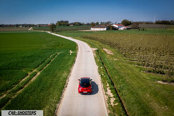 Toyota Corolla Hybrid – rear view, red on a country road