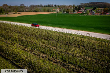 Toyota Corolla Hybrid – side profile, red on a country road