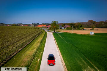 Toyota Corolla Hybrid – front three-quarter, red on a country road