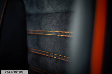detail, alcantara seat upholstery with orange stitching