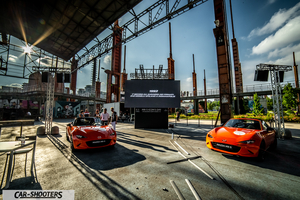 Mazda MX 5 Icon s Day – front three-quarter, orange at an industrial event space
