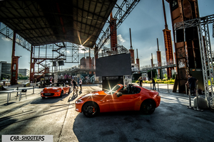 Mazda MX 5 Icon s Day – front three-quarter, orange in an industrial venue