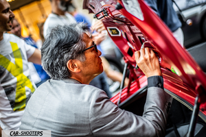 detail, person signing car trunk lid