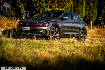 Volkswagen Polo GTI – front three-quarter, grey metallic on a grassy field