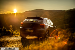 Volkswagen Polo GTI – rear three-quarter, grey against a mountain backdrop at sunset