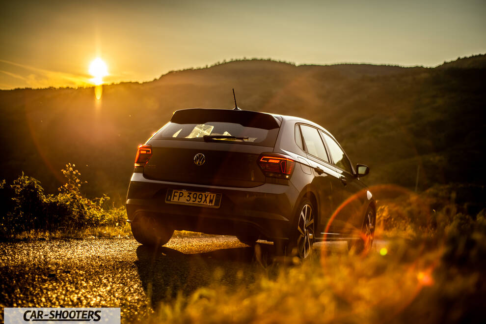 Volkswagen Polo GTI – rear three-quarter, grey against a mountain backdrop at sunset