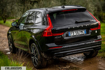 Volvo XC60 Polestar – rear three-quarter, black on a dirt road