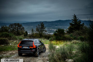 Volvo XC60 Polestar – rear three-quarter, black against a mountain backdrop