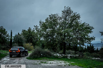 Volvo XC60 Polestar – rear three-quarter, black on a country road