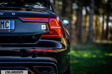 Volvo s60 polestar – rear view, black against a wooded background