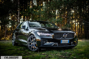 Volvo s60 polestar – front three-quarter, black on a grassy forest path