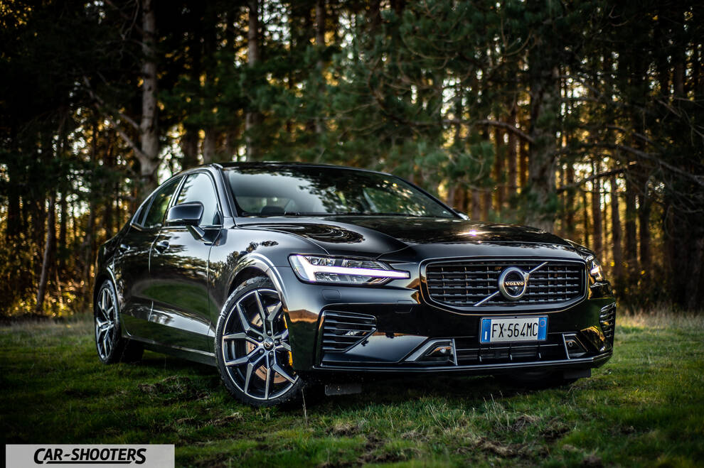 Volvo s60 polestar – front three-quarter, black on a grassy forest path