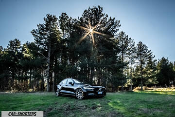 Volvo s60 polestar – front three-quarter, black against a tree backdrop
