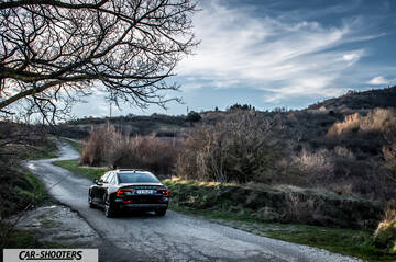 Volvo s60 polestar – rear three-quarter, black on a country road