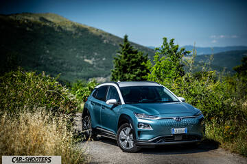 Hyundai Kona electric – front three-quarter, teal against a mountain backdrop