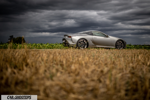 Lexus LC500h – side profile, silver in a field under stormy skies