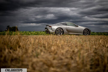 Lexus LC500h – side profile, silver in a field under stormy skies