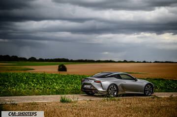 Lexus LC500h – rear three-quarter, silver metallic on a country road