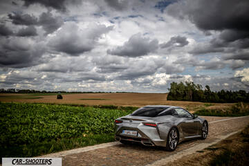 Lexus LC500h – rear three-quarter, silver metallic on a country road