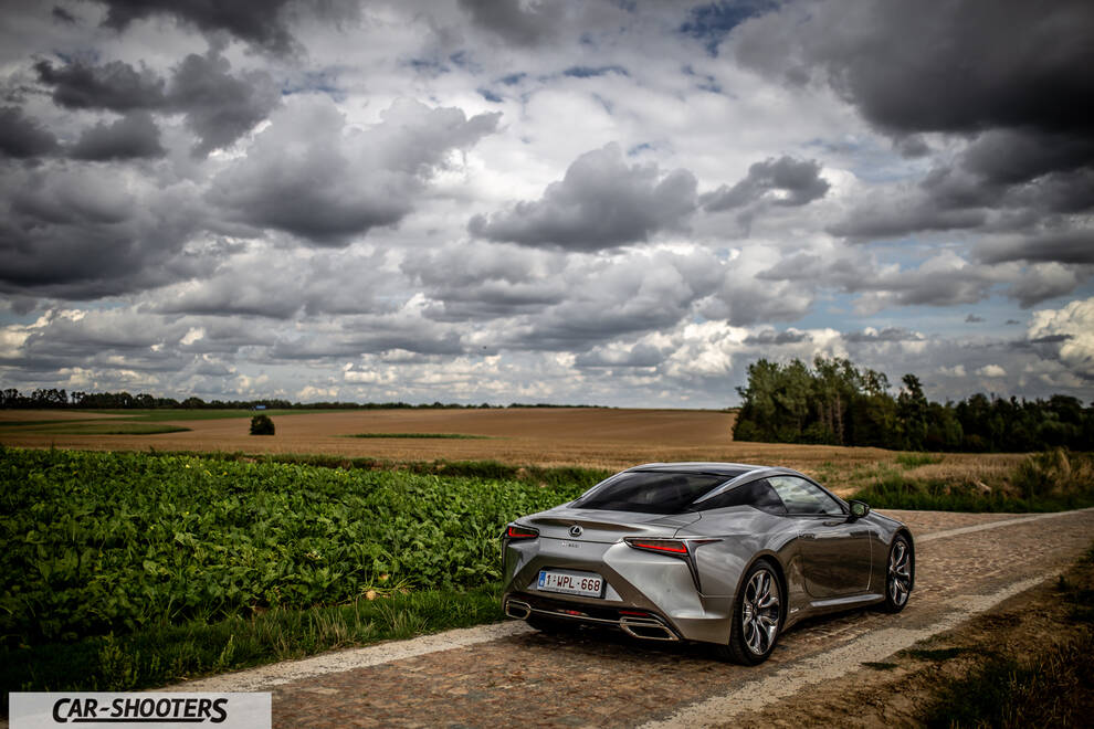 Lexus LC500h – rear three-quarter, silver metallic on a country road