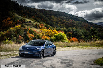 Tesla Model S Performance – front three-quarter, dark blue against a mountain backdrop